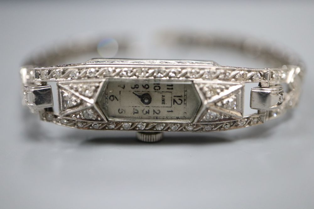 A ladys mid 20th century white metal (tests as platinum) and diamond set cocktail wrist watch, on diamond set bracelet, 16.5cm,